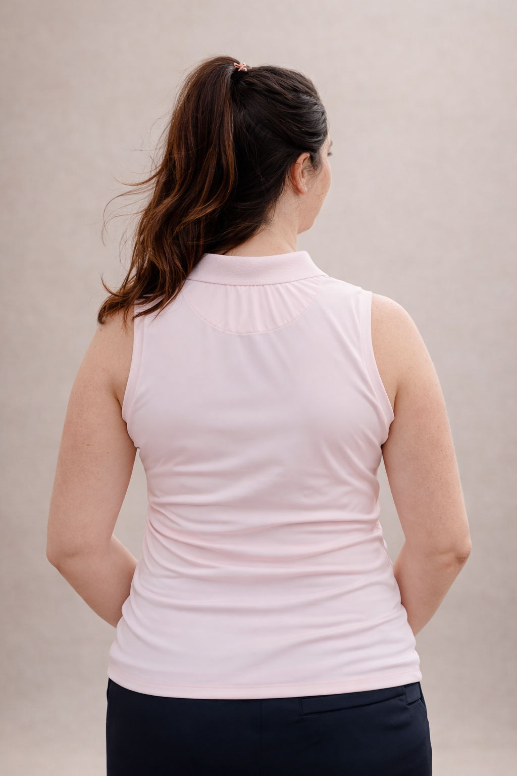 Pregnant Woman wearing a light pink sleeveless active wear